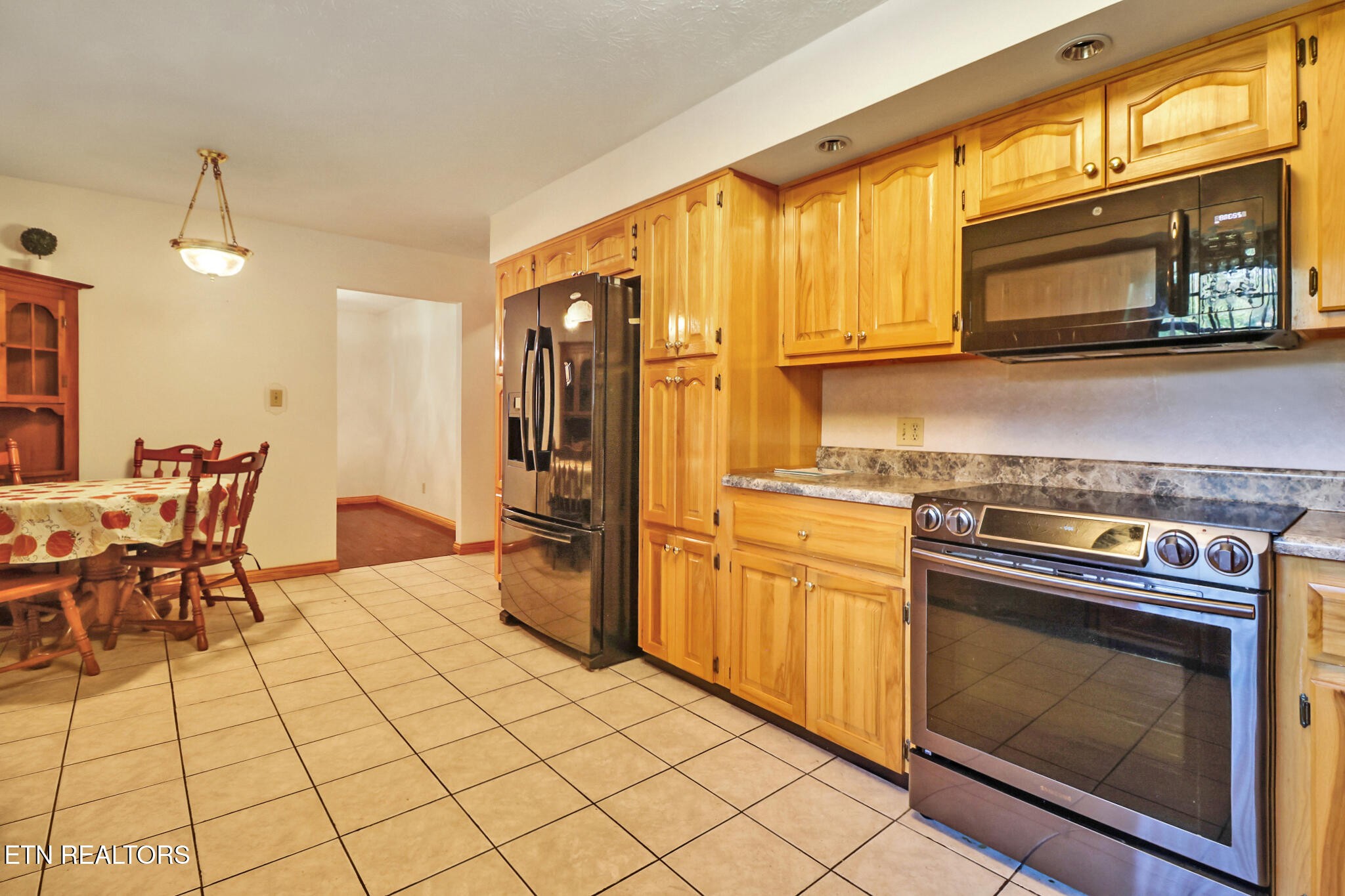 1190 Sand Cut Road Oneida, TN 37841 - Photo 6 of 41 a kitchen with stainless steel appliances granite countertop a stove a sink and a microwave