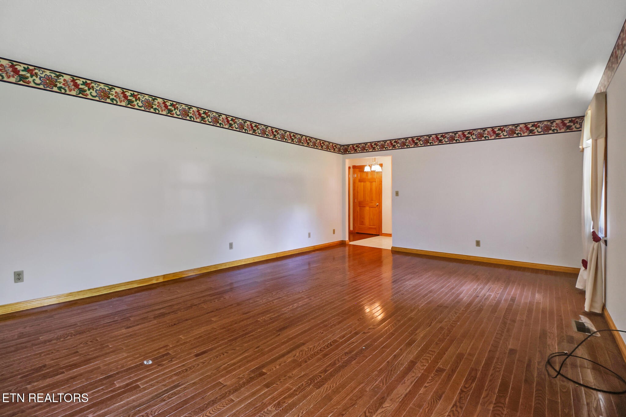 1190 Sand Cut Road Oneida, TN 37841 - Photo 10 of 41 a view of a room with wooden floor and white walls