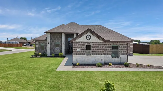 a front view of a house with a yard