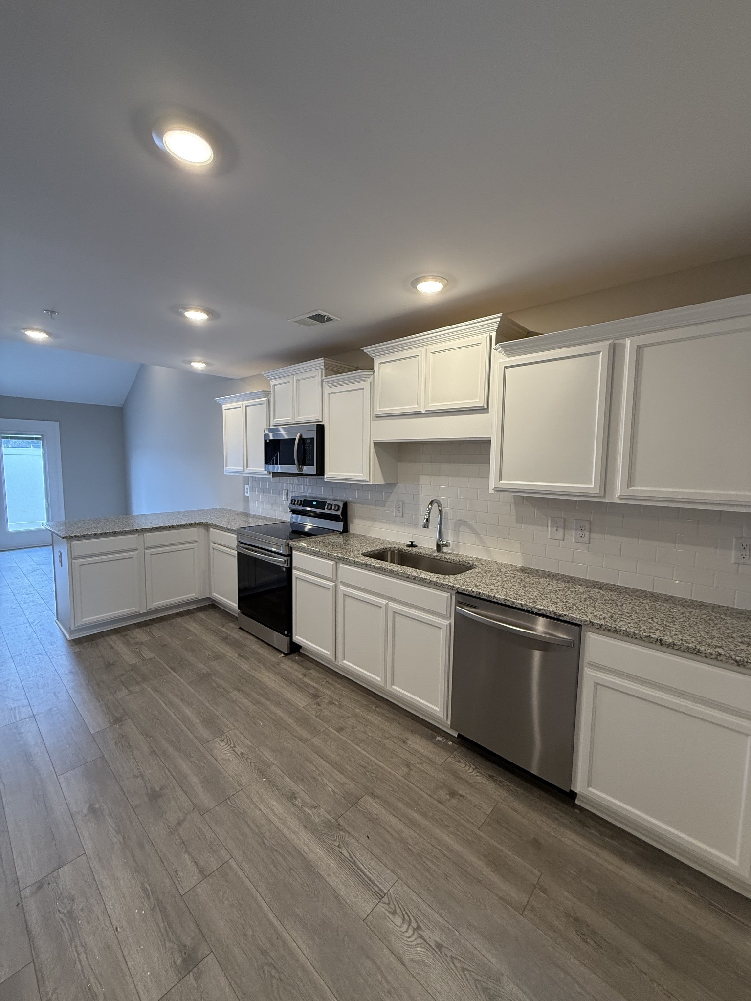 316 Selesia Lane Pleasant View, TN 37146 - Photo 4 of 16 a large kitchen with stainless steel appliances granite countertop a stove and a sink