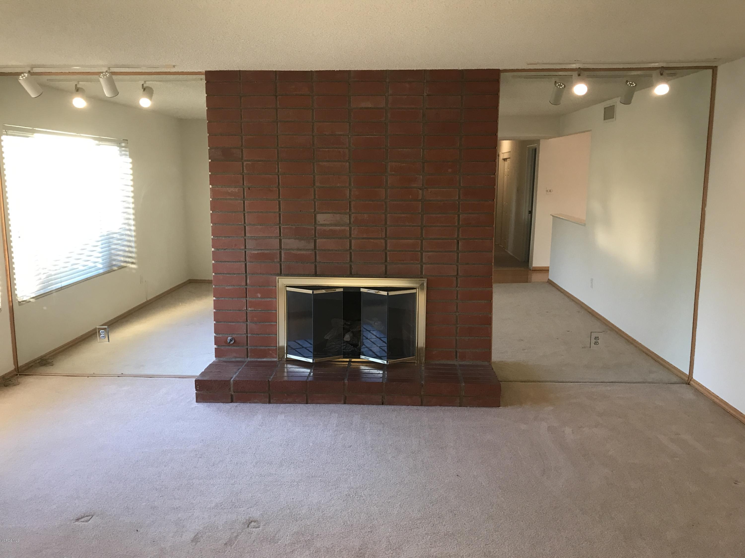 3920 Russ Court Simi Valley, CA 93063 - Photo 12 of 32 a living room with a fireplace and a large window