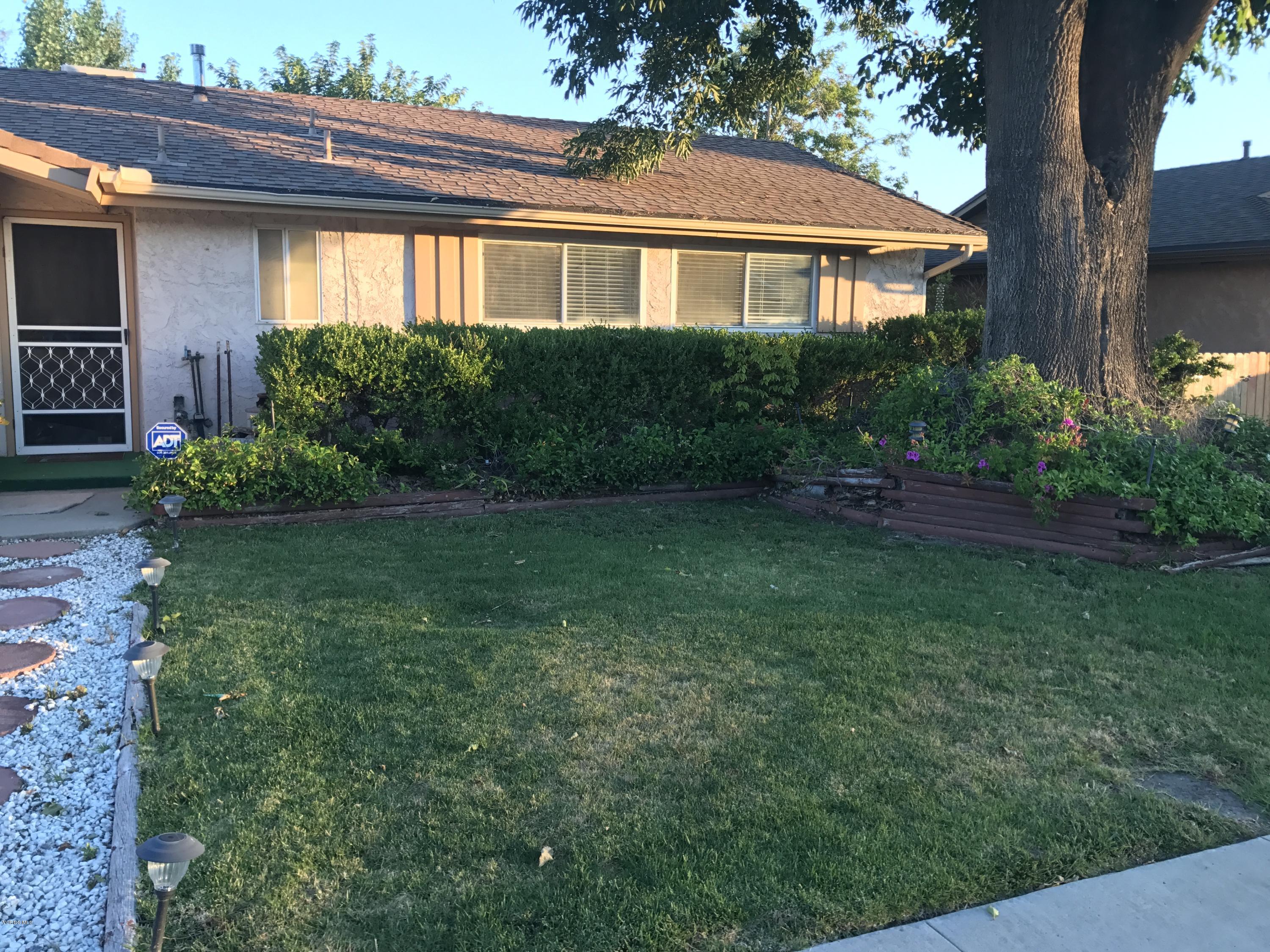 3920 Russ Court Simi Valley, CA 93063 - Photo 4 of 32 a front view of a house with a yard and green space