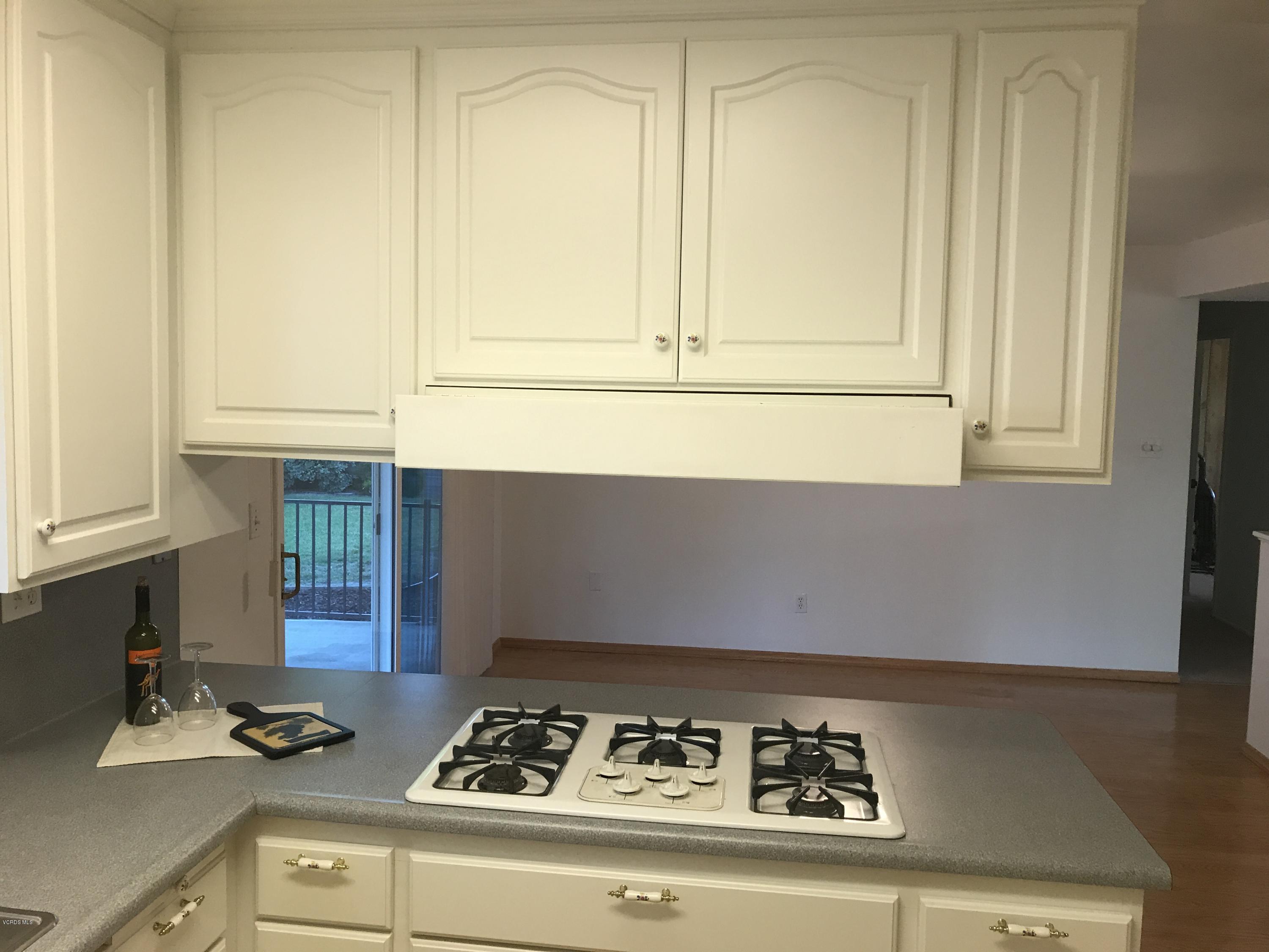 3920 Russ Court Simi Valley, CA 93063 - Photo 9 of 32 a kitchen with a stove and a cabinet