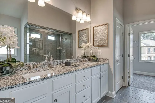 a bathroom with double vanity sinks and a mirror