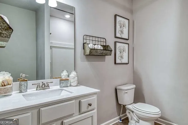 a bathroom with a toilet a sink and mirror