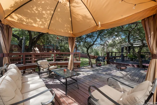 a view of a patio with table and chairs under an umbrella