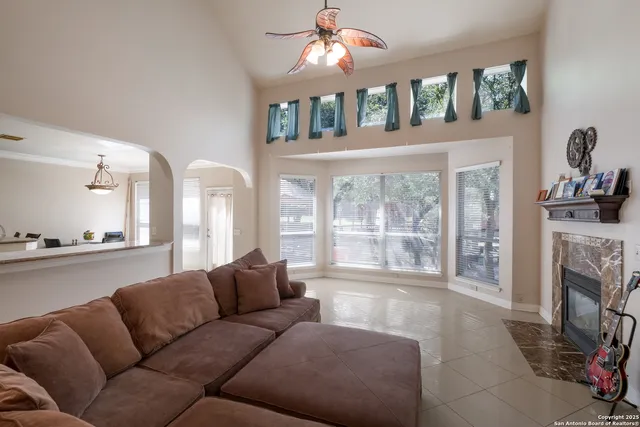 a living room with furniture a fireplace and a flat screen tv
