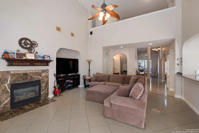 a living room with furniture a fireplace and a flat screen tv