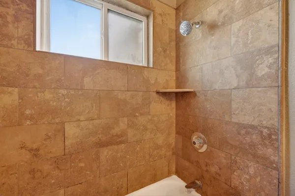 a bathroom with a sink vanity granite and a mirror