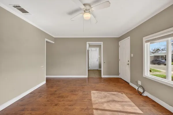 wooden floor in an empty room with a window