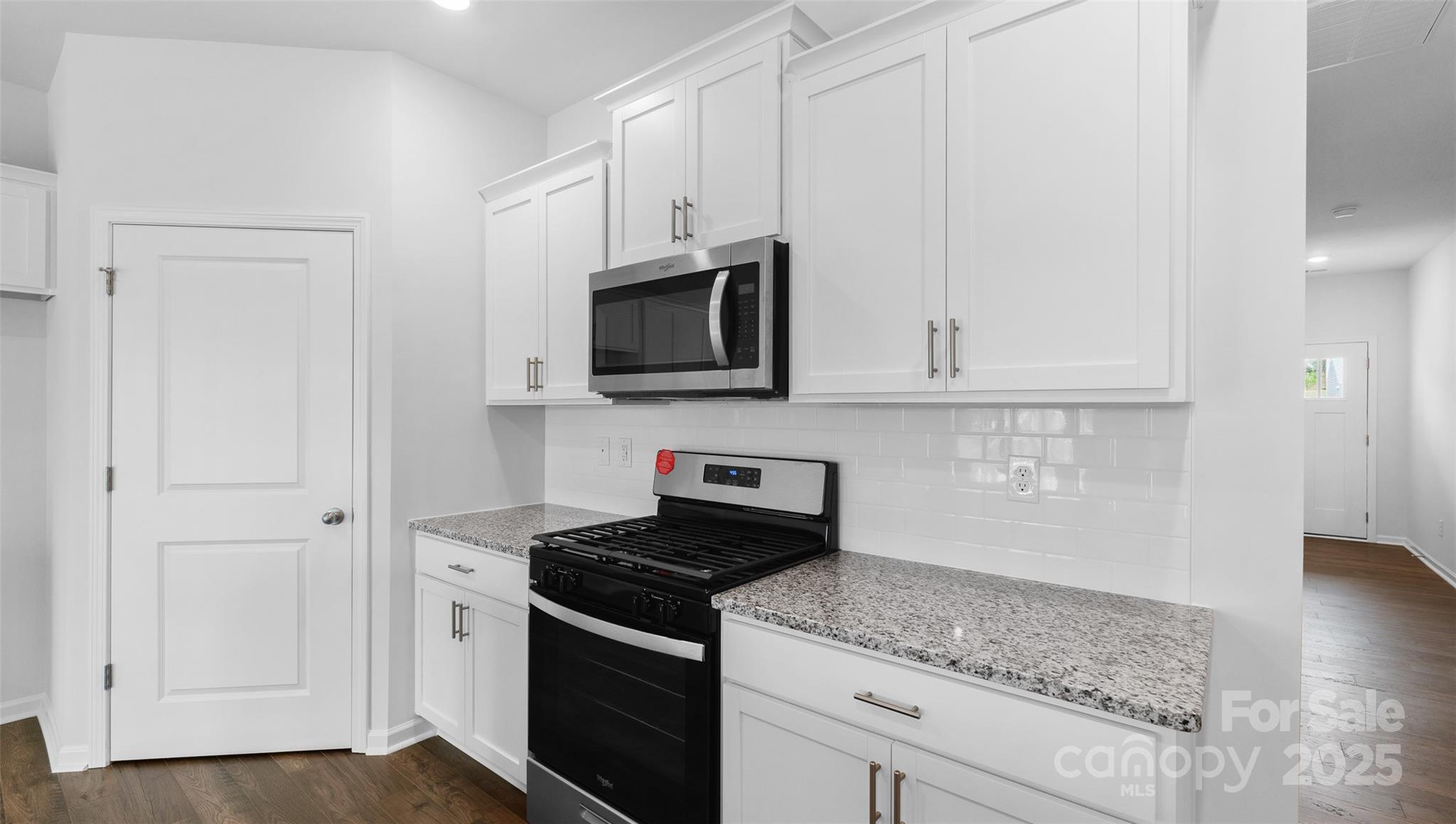 111 Ridgehaven Drive Waynesville, NC 28786 - Photo 7 of 21 a kitchen with stainless steel appliances granite countertop white cabinets and a stove top oven