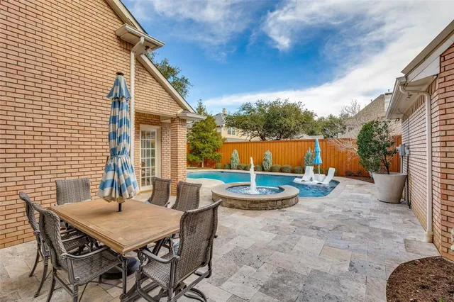 a view of a patio with table and chairs and potted plants