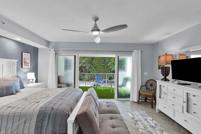 a bedroom with furniture and a flat screen tv