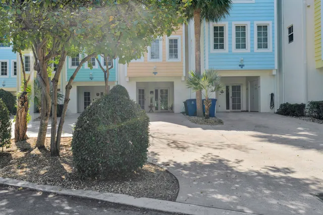 a front view of a house with yard and trees
