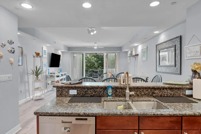 a kitchen with granite countertop a sink and a stove top oven