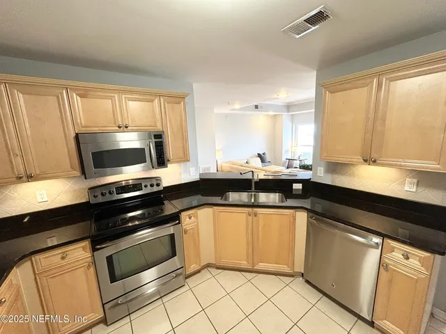 a bedroom with a bed and a large mirror