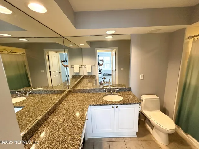 a view of a tall building and a palm tree