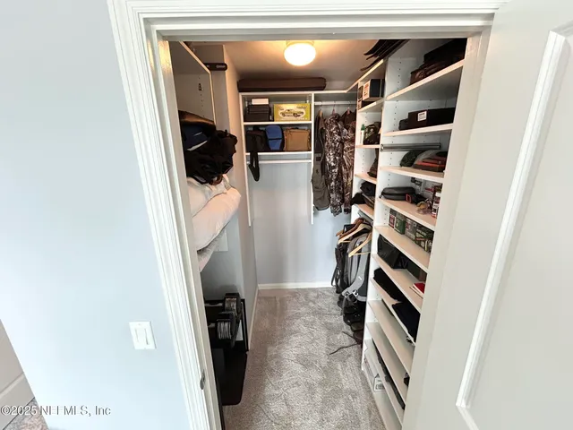 a living room with furniture a fireplace and a large window
