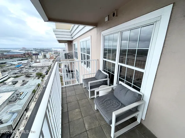 a living room with furniture a bookshelf and a fireplace