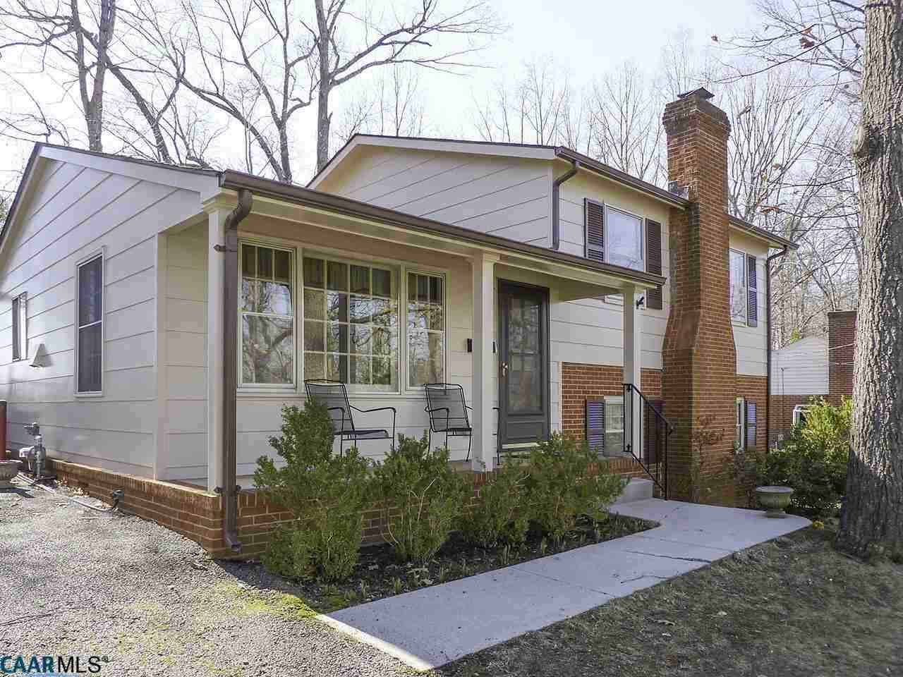 606 Shamrock Road Charlottesville, VA 22903 - Photo 1 of 19 a view of a white house with large windows and a small yard