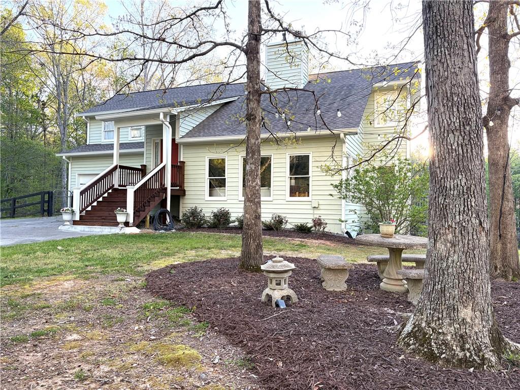 402 Hunters Court Ball Ground, GA 30107 - Photo 1 of 56 a view of a house with backyard and a tree