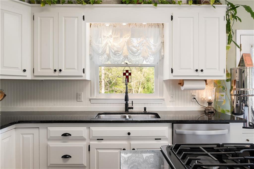 402 Hunters Court Ball Ground, GA 30107 - Photo 11 of 56 a kitchen with stainless steel appliances white cabinets and a window