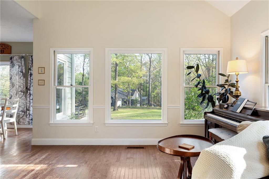 402 Hunters Court Ball Ground, GA 30107 - Photo 14 of 56 a view of a livingroom with furniture window and wooden floor