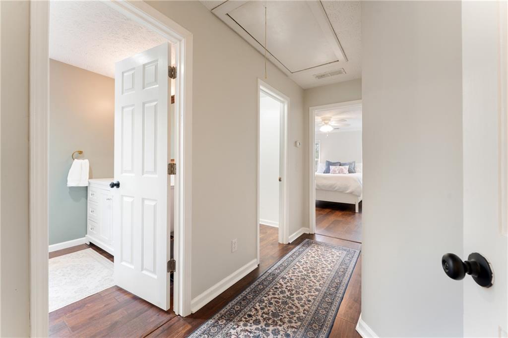 402 Hunters Court Ball Ground, GA 30107 - Photo 15 of 56 a view of a hallway with wooden floor and a bathroom
