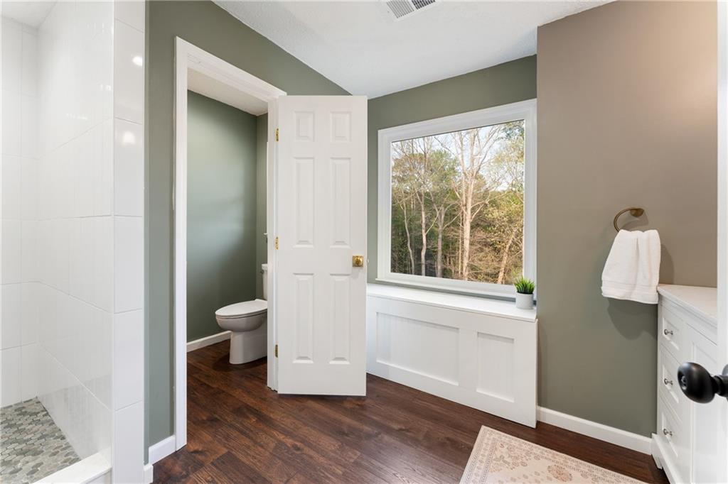 402 Hunters Court Ball Ground, GA 30107 - Photo 16 of 56 a bathroom with a toilet shower and window