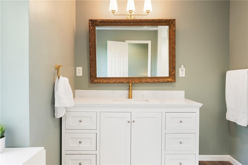 402 Hunters Court Ball Ground, GA 30107 - Photo 17 of 56 a bathroom with a sink vanity and mirror