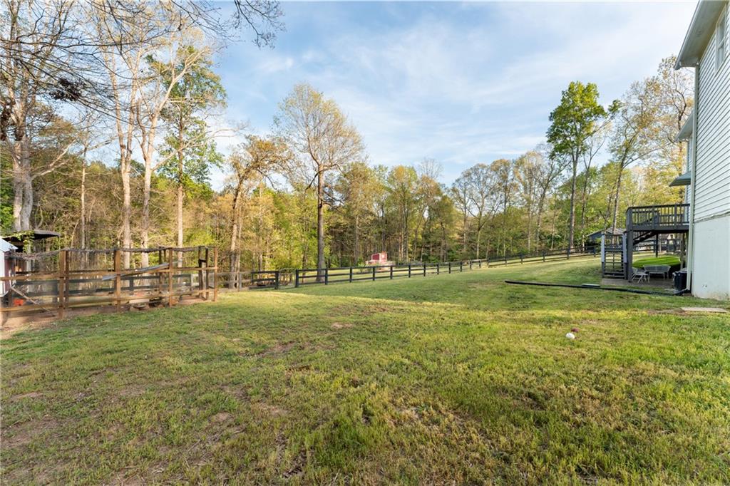 402 Hunters Court Ball Ground, GA 30107 - Photo 2 of 56 a view of a field of grass and trees