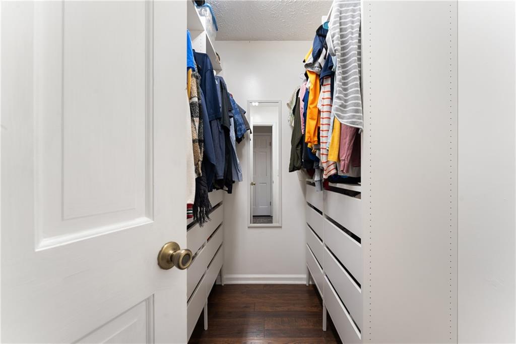 402 Hunters Court Ball Ground, GA 30107 - Photo 21 of 56 a view of walk in closet with clothes