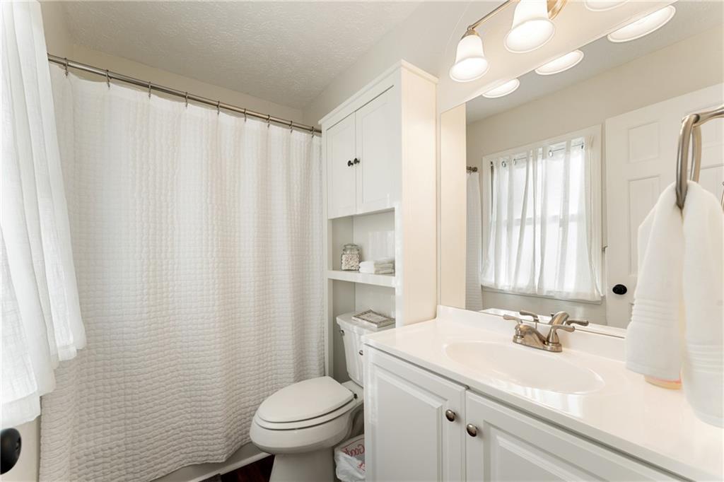 402 Hunters Court Ball Ground, GA 30107 - Photo 22 of 56 a bathroom with a sink a toilet and a mirror