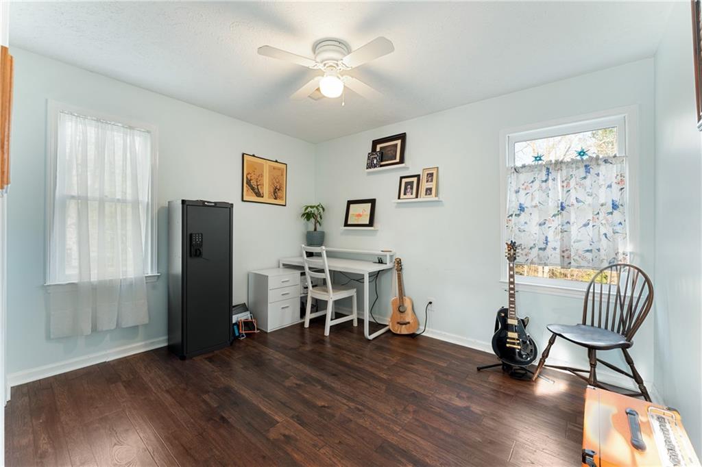 402 Hunters Court Ball Ground, GA 30107 - Photo 23 of 56 a view of a livingroom with furniture and a ceiling fan