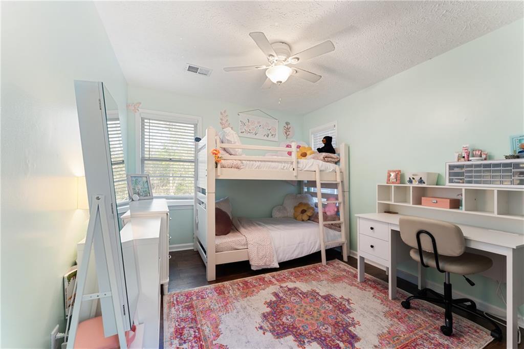 402 Hunters Court Ball Ground, GA 30107 - Photo 24 of 56 a bedroom with a bed and a desk
