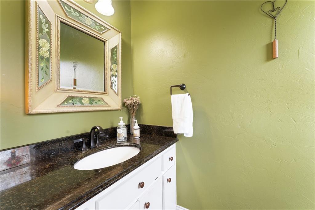 402 Hunters Court Ball Ground, GA 30107 - Photo 26 of 56 a bathroom with a granite countertop sink and a mirror
