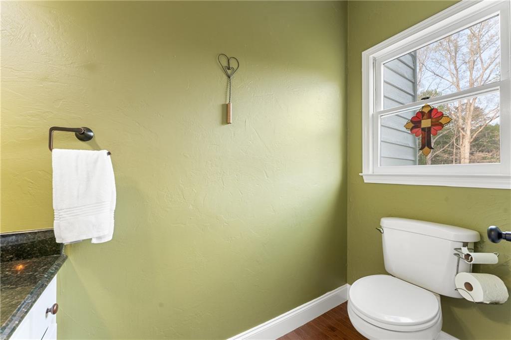 402 Hunters Court Ball Ground, GA 30107 - Photo 27 of 56 a white toilet sitting next to a bathroom sink