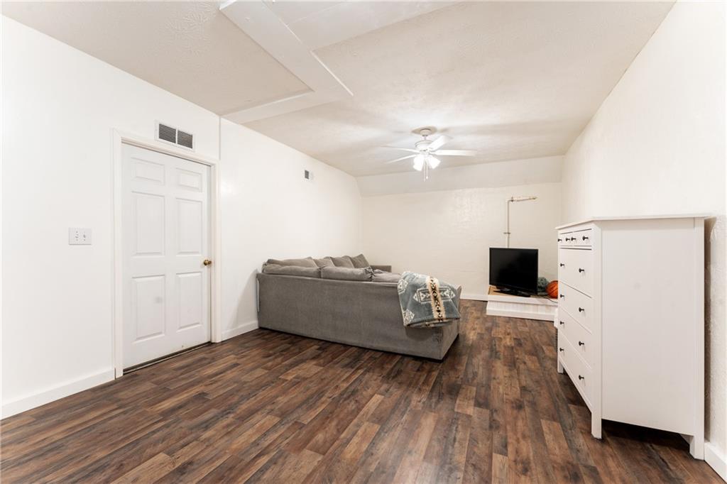 402 Hunters Court Ball Ground, GA 30107 - Photo 30 of 56 a living room with furniture and a flat screen tv