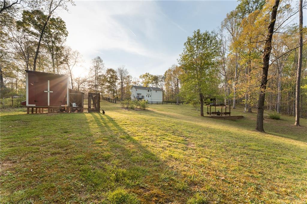 402 Hunters Court Ball Ground, GA 30107 - Photo 3 of 56 a view of yard with swimming pool and trees