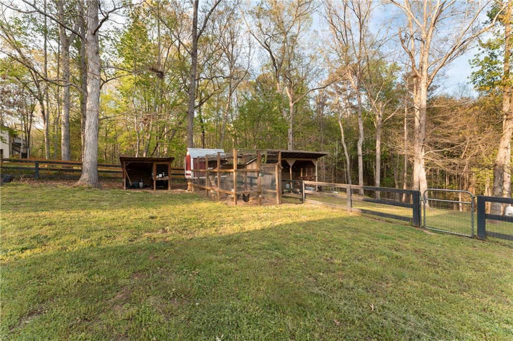 402 Hunters Court Ball Ground, GA 30107 - Photo 36 of 56 a view of a house with a yard porch and sitting area