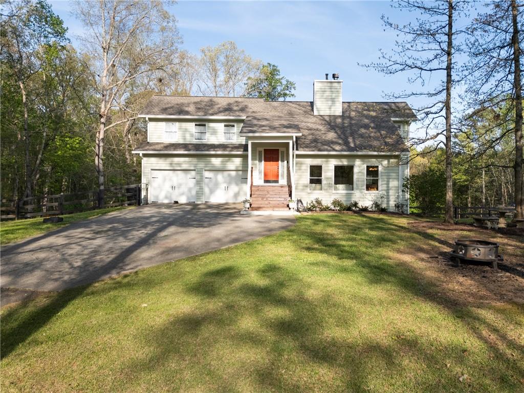 402 Hunters Court Ball Ground, GA 30107 - Photo 45 of 56 a front view of a house with a yard