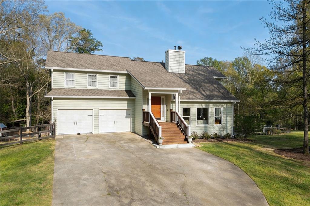 402 Hunters Court Ball Ground, GA 30107 - Photo 46 of 56 a front view of a house with garden and trees