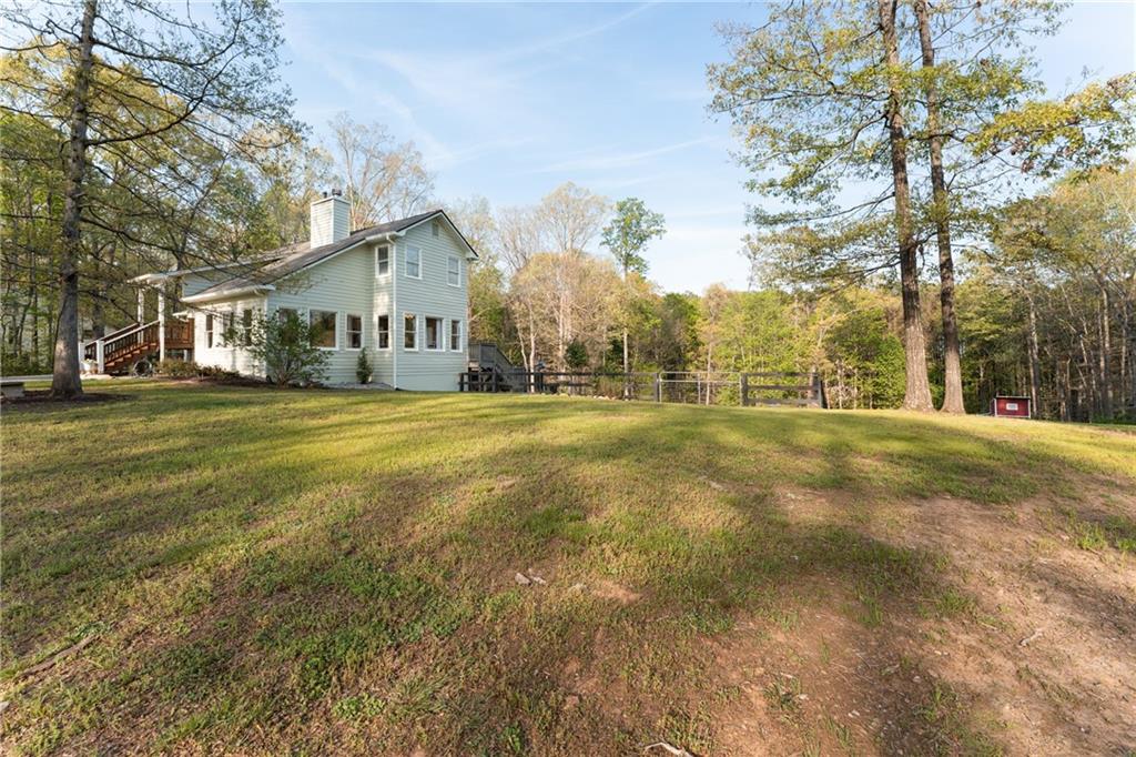 402 Hunters Court Ball Ground, GA 30107 - Photo 52 of 56 a view of a house with a yard