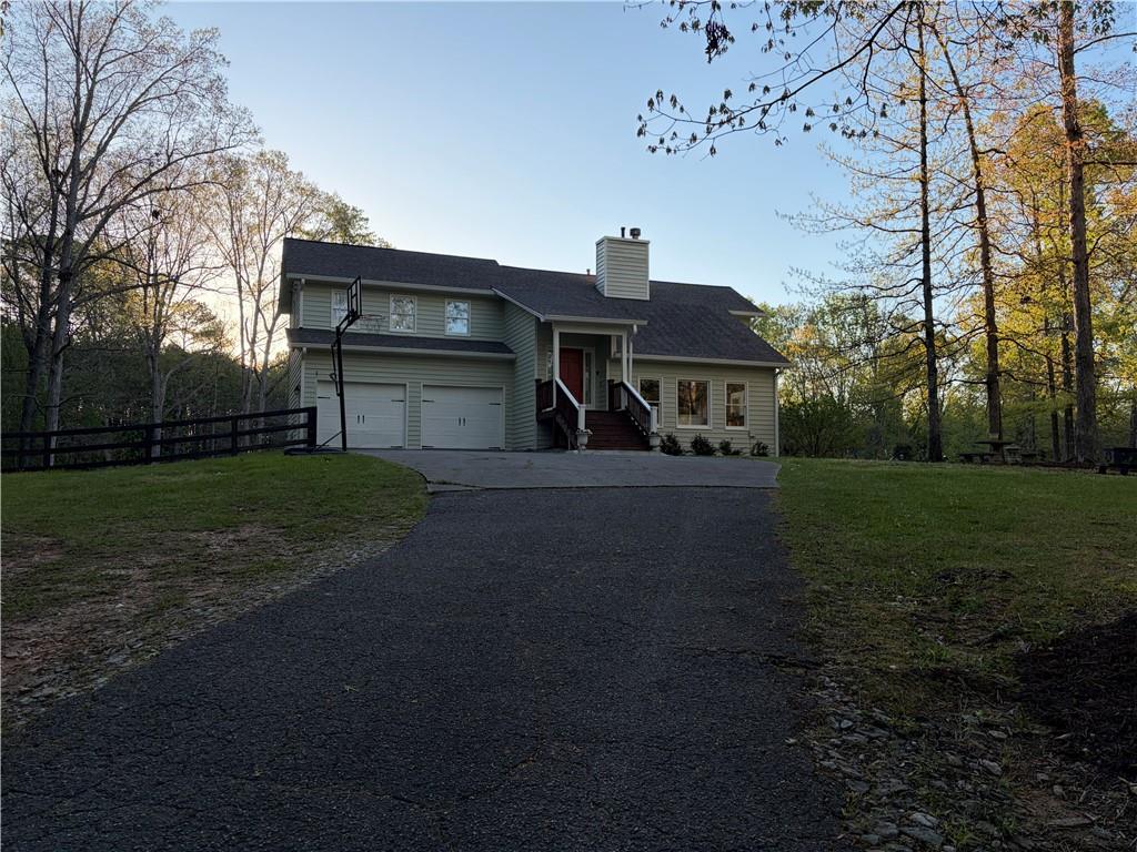 402 Hunters Court Ball Ground, GA 30107 - Photo 54 of 56 a front view of a house with a yard