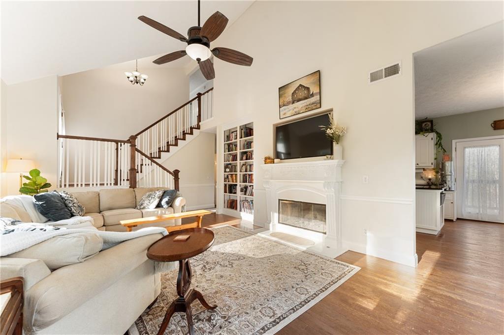 402 Hunters Court Ball Ground, GA 30107 - Photo 7 of 56 a living room with furniture and a fireplace