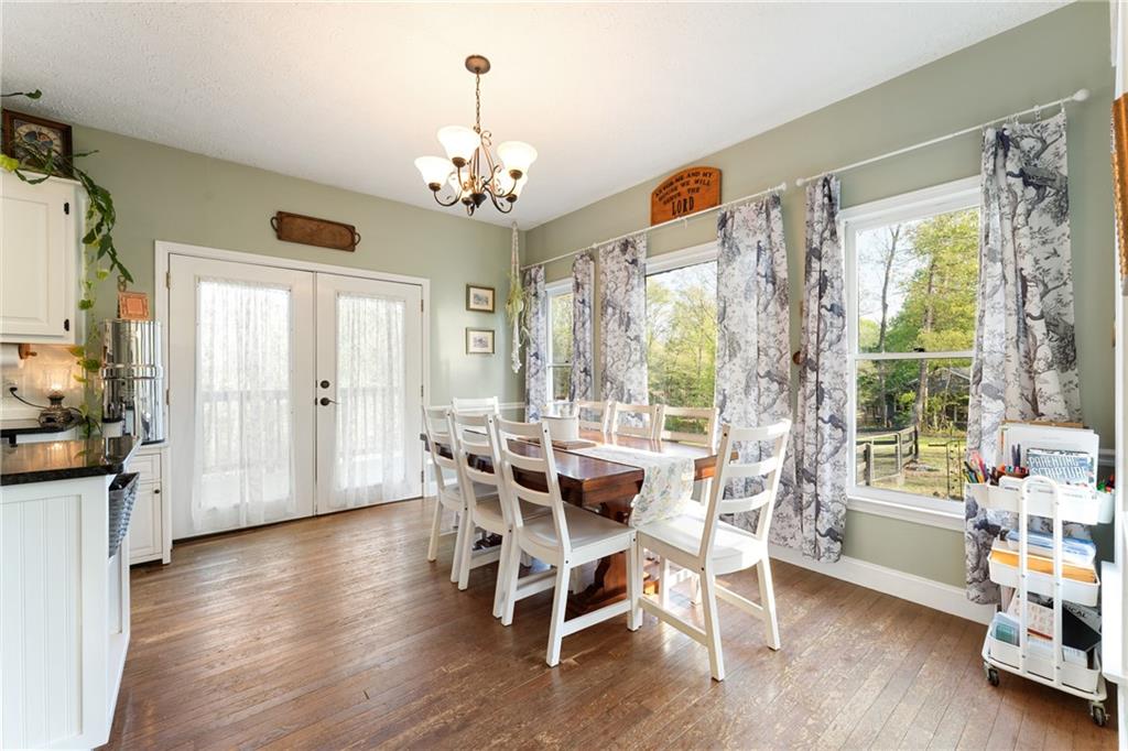 402 Hunters Court Ball Ground, GA 30107 - Photo 8 of 56 a view of a dining room with furniture window and wooden floor