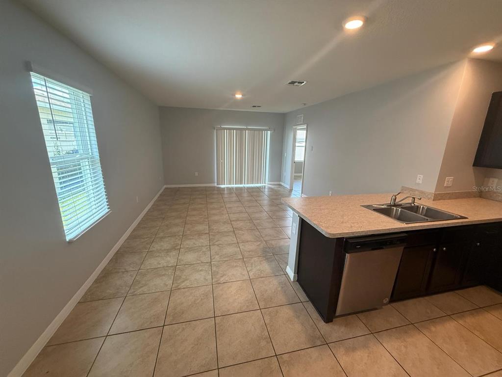 754 Chinoy Road Davenport, FL 33837 - Photo 15 of 26 a kitchen with a sink a mirror and cabinets