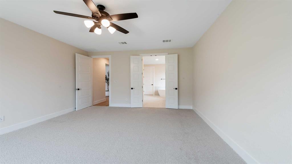854 Stoney Bridge Way Lavon, TX 75166 - Photo 13 of 36 an empty room with chandelier fan and windows