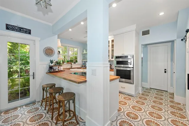 a kitchen with a sink cabinets and window