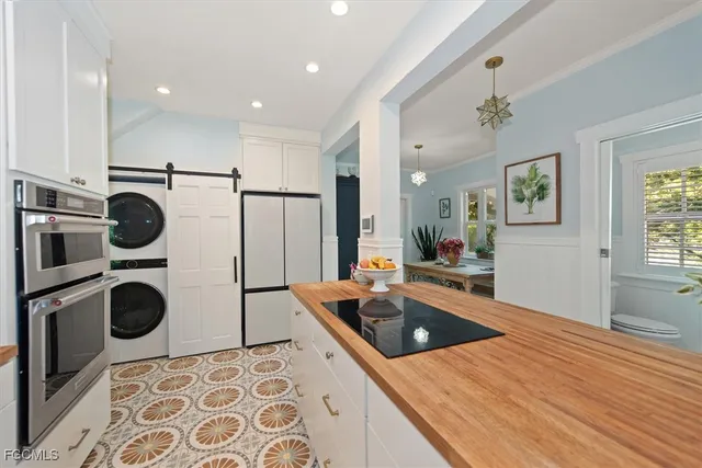 a kitchen with a sink a stove and cabinets